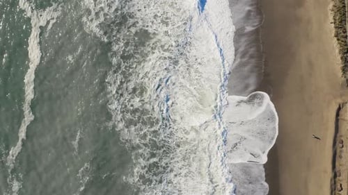 Ocean wave splash into the sand