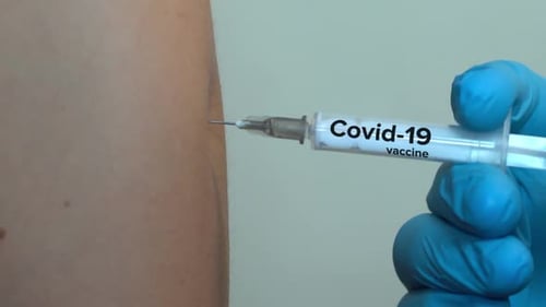 Syringe Injecting Covid-19 Vaccine into Arm
