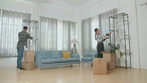 Couple Unpacking Belongings in Their New Living Room