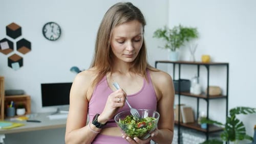 Woman Eating Salad at Home