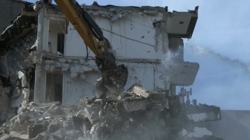 Building Demolition Using Heavy Machinery on Construction Site