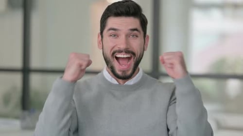 Man Expressing Happiness in Office Setting