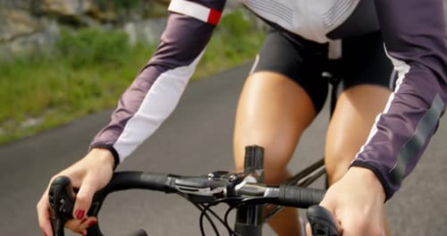 Female cyclist cycling on a countryside road