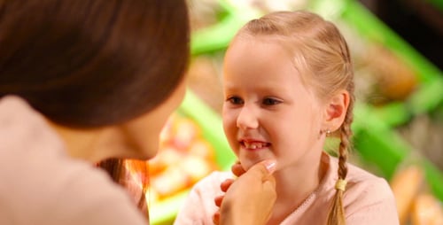 Mother and Daughter Talking in Grocery Store Close Up