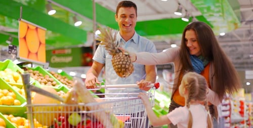 Family Shopping for Groceries at Supermarket