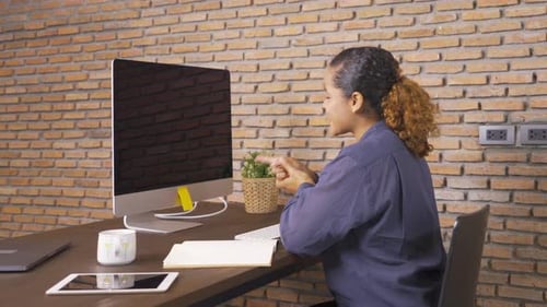 Smiling African American business woman, black person working from home with blank screen computer