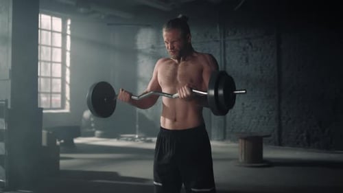 Man Lifting Weights in Sport Club