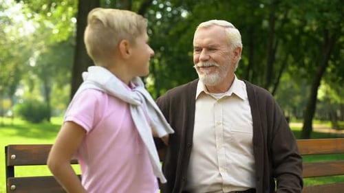 Grandfather and Grandson Together on Park Bench