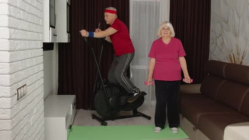 Active Senior Couple Doing Home Fitness Workout