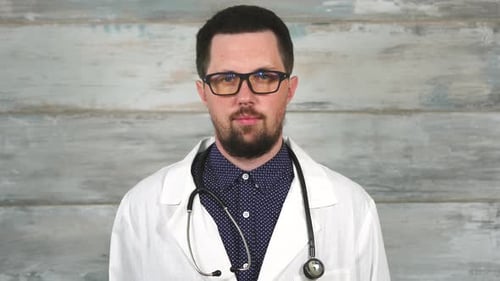 Bearded Doctor with Stethoscope Poses for Camera