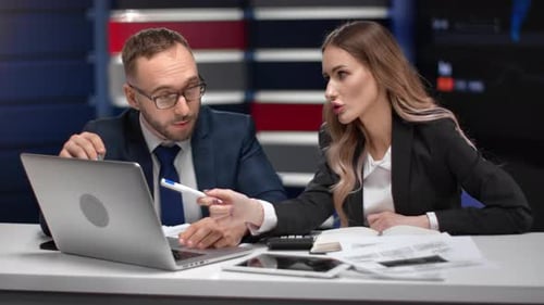 Business Man and Woman Discussing Job at Formal Meeting Pointing on Screen of Laptop Analyzing