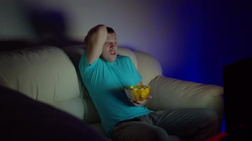 Man Watching TV with an Distraught Expression
