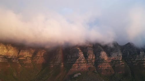 Fog Moving Across the Peak of Table Mountain Creating a Rainbow on the Lenses