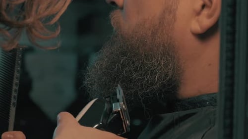 Bearded Adult Getting Beard Trimmed at Barbershop