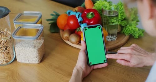 Nutritionist Woman with Healthy Fruit and Vegetable Using Smartphone with Green Screen