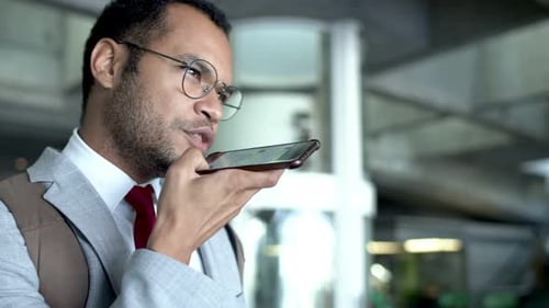 Adult Man Recording Voice Message on Smartphone