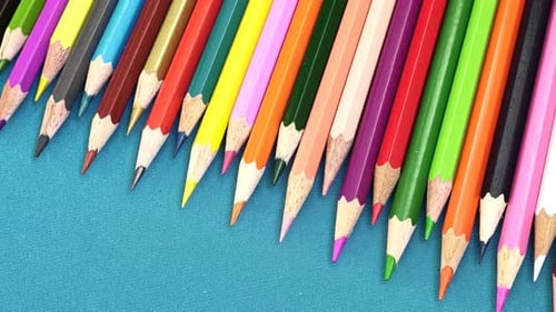 Colorful Pencils Arranged on a Blue Surface