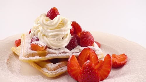Waffles Topped with Strawberries and Whipped Cream