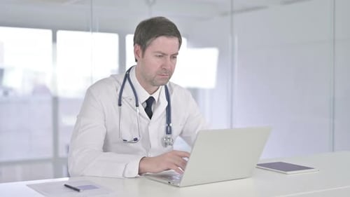 Middle Aged Doctor Smiling at the Camera in Office