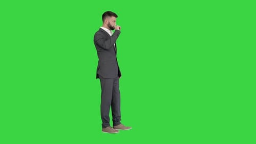Businessman with a Beard Showing Gestures Finger Up Thumbs Up on a Green Screen Chroma Key