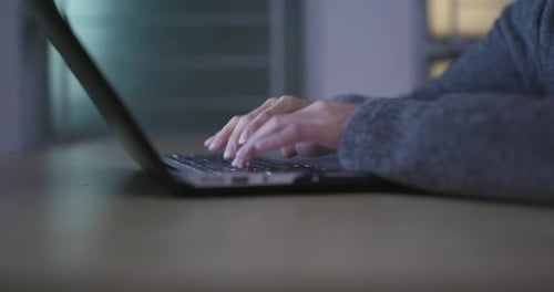Working on laptop computer at home in the evening