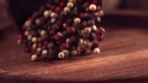 Multi-Colored Peppercorns Pouring in Slow Motion