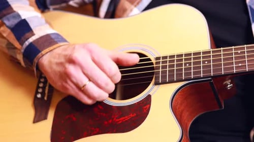 Close Up Man Playing on Guitar at Home Learning and Tune