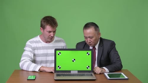 Businessmen Excited About Green Screen Laptop