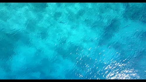 Aerial drone scenery of relaxing shore beach journey by blue green water and white sandy background