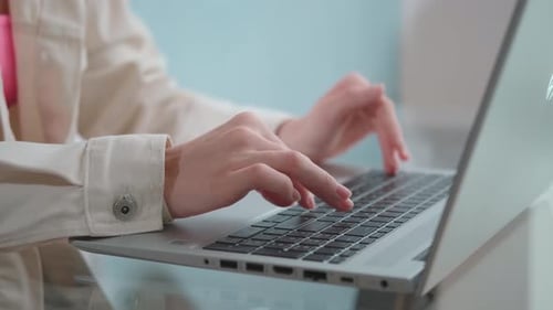 Woman Typing on Laptop Keyboard Close Up