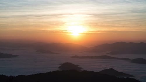 Golden Sunrise Over Misty Mountain Peaks