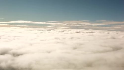 A panning shot of the top of a beautiful blanket of clouds.