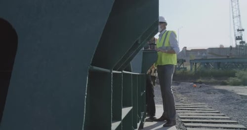 Engineers Inspecting Construction Plans on Site