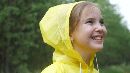 Girl Smiling Wearing Raincoat on a Rainy Day