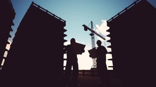 Construction Workers Silhouettes on Building Site with Crane