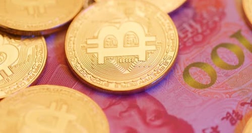 Bitcoin Coins on Chinese Yuan Renminbi Banknote