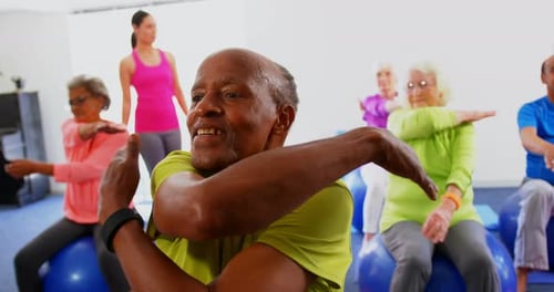 Front view of Caucasian female trainer training senior people in exercise at fitness studio 4k