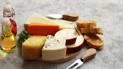 Cheese Board with Bread and Oils on Table