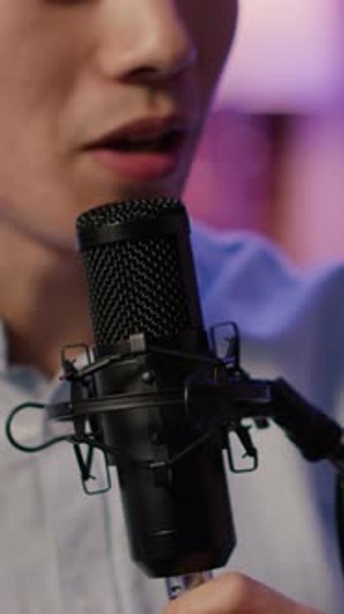 Young Adult Adjusting Professional Recording Microphone