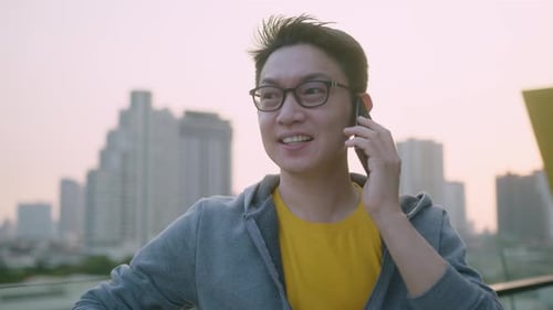 Man Chatting on Phone with City View