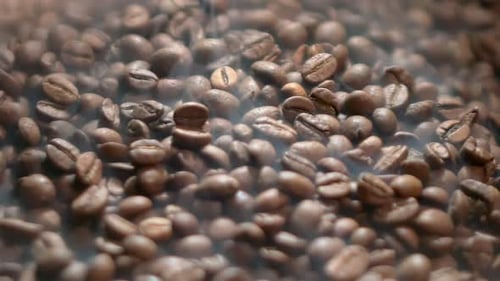 A Closeup of a Heap of Brown Fragrant Coffee Beans Being Roasted in a Coffee Production Factory