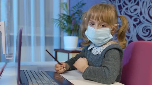 Girl Studying At Desk Wearing Face Mask
