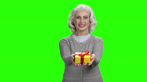 Smiling Senior Woman Holding Gift Box