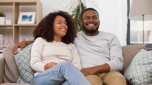 Happy Couple Relaxing on Couch in Living Room