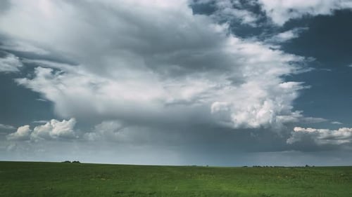 Dramatic Sky Before Rain With Rain Clouds On Horizon Above Rural Landscape Field Meadow