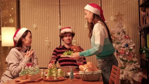 Friends celebrate Christmas with festive meal and drinks