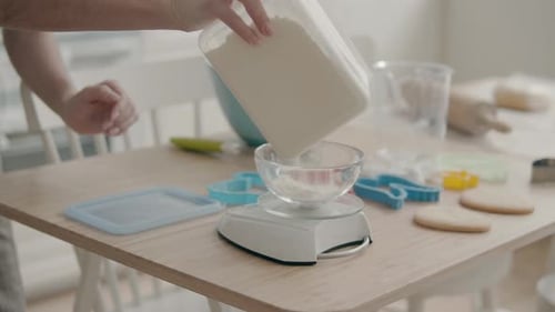 Woman Measuring Flour for Baking Cookies at Home