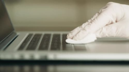 Gloved Hand Wipes Laptop Keyboard Clean