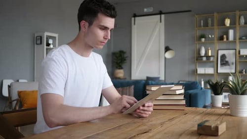 Young Adult Using a Tablet at Home