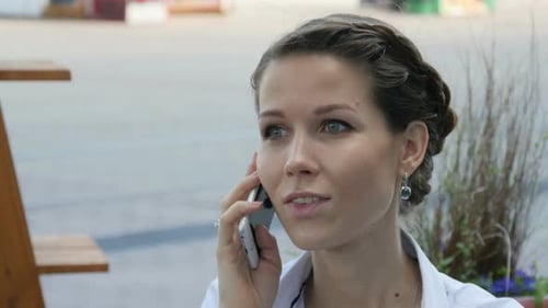 Woman Talking on Phone in an Urban Setting